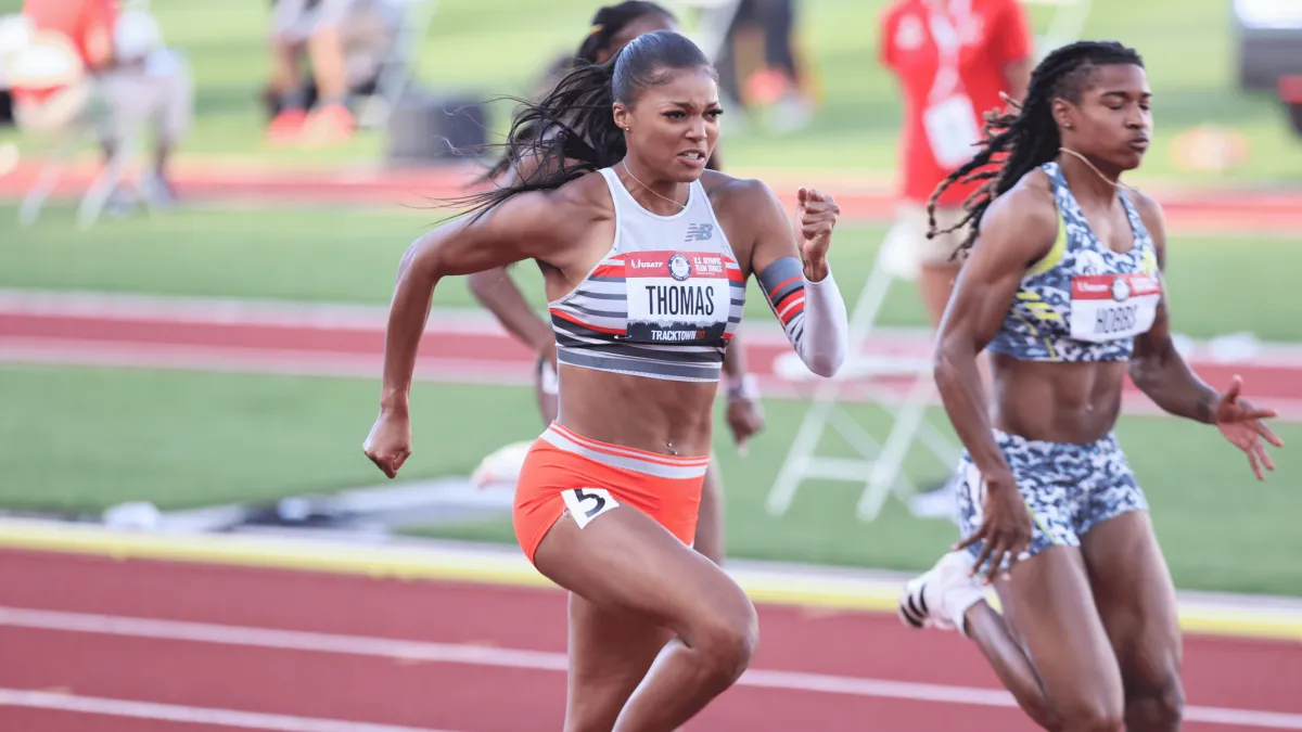 Gabrielle Thomas running a race on the race track with another runner to her left. 