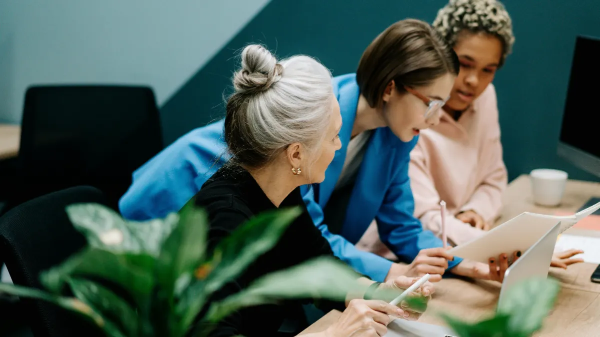 Photo of 3 people collaborating at work