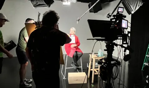 Behind the scenes image of a film studio, filming for a course.