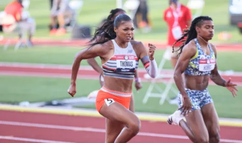 Olympian Gabby Thomas running a race on the track.