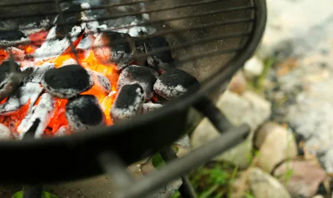 Photo of a charcoal grill with lit charcoals.